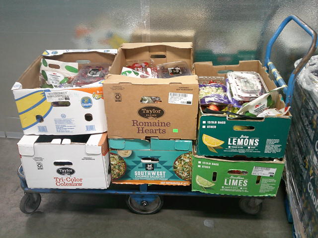 Produce boxes filled with produce on a cart.
